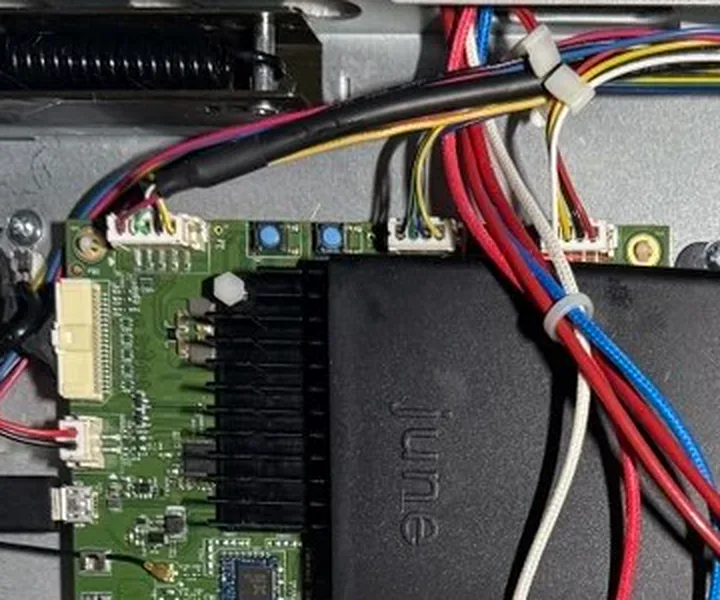 Close-up of the oven's main board with the bottom plate off. Two blue buttons sit along the top edge of the board, beside the black heatsink; a red arrow points to the right-hand one, SW2. A second red arrow points to the micro-USB port on the board's left edge.